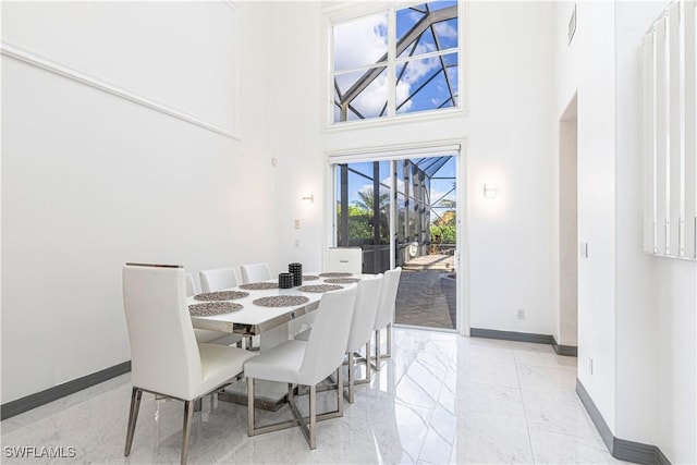 dining space with a towering ceiling