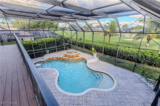 view of swimming pool featuring glass enclosure and an in ground hot tub