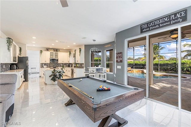 recreation room featuring ceiling fan, sink, and billiards