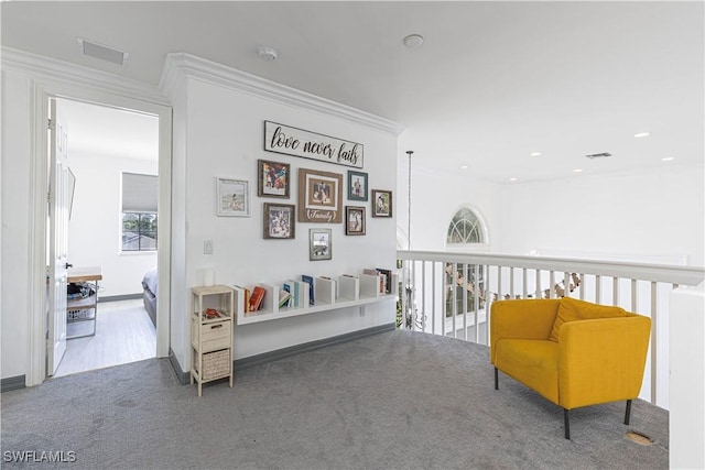 sitting room featuring carpet flooring and crown molding