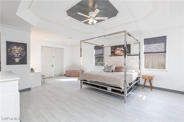 bedroom featuring a raised ceiling, ceiling fan, and ornamental molding