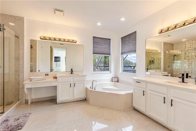 bathroom featuring vanity and shower with separate bathtub