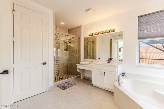 bathroom featuring vanity and separate shower and tub