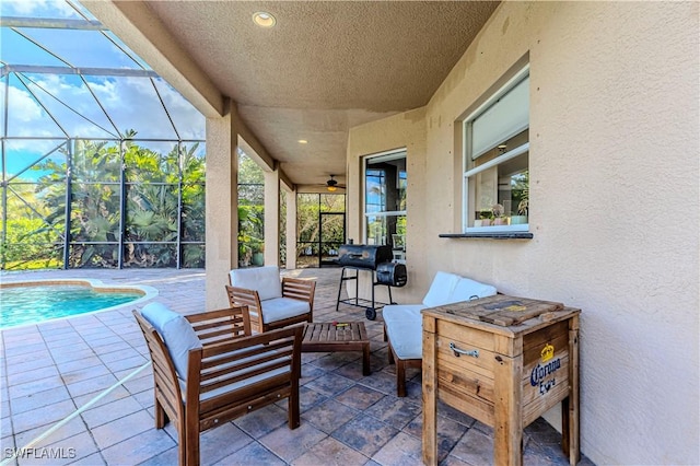 view of patio with a lanai, outdoor lounge area, and grilling area