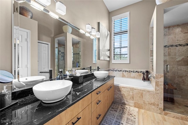 bathroom featuring vanity and shower with separate bathtub