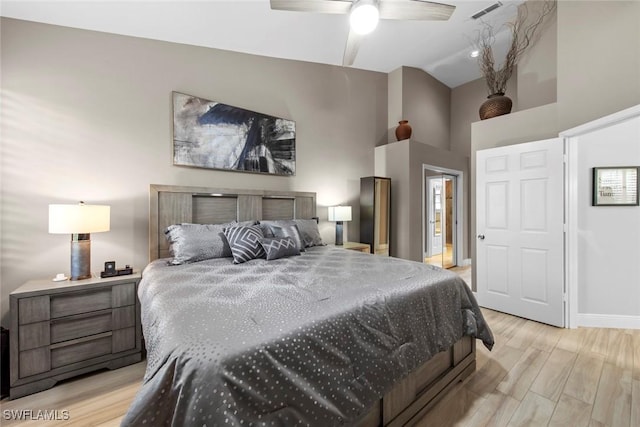 bedroom featuring ceiling fan, light wood-type flooring, and lofted ceiling