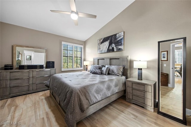 bedroom with ceiling fan, light wood-type flooring, and lofted ceiling