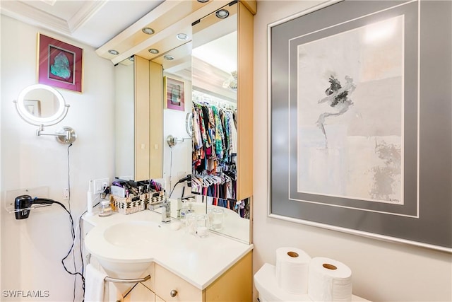 bathroom with vanity and ornamental molding