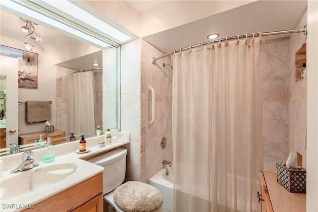 full bathroom with vanity, shower / bath combo, and toilet