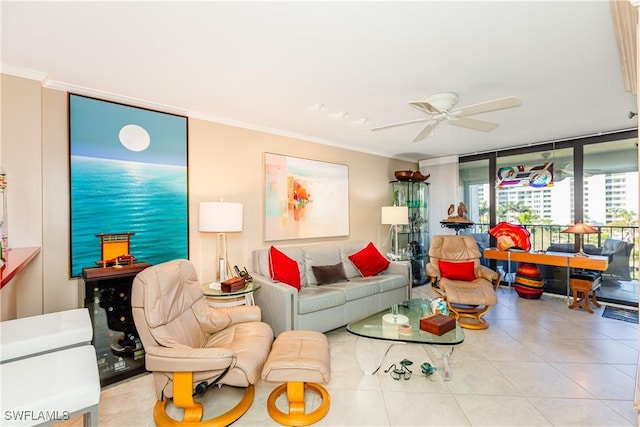 tiled living room with ceiling fan, a wall of windows, and crown molding