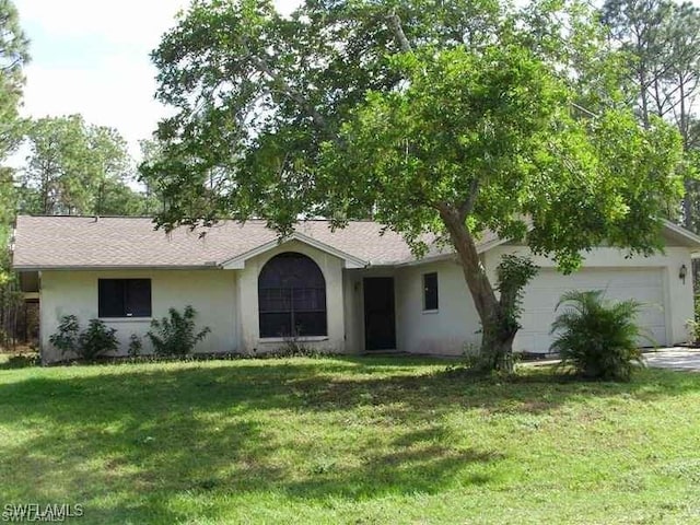 ranch-style house featuring a garage and a front yard