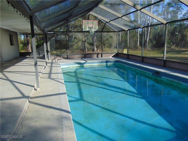 view of swimming pool with a lanai and a patio area