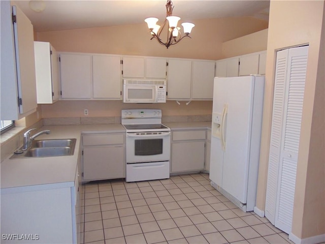 kitchen featuring vaulted ceiling, white cabinetry, sink, and white appliances