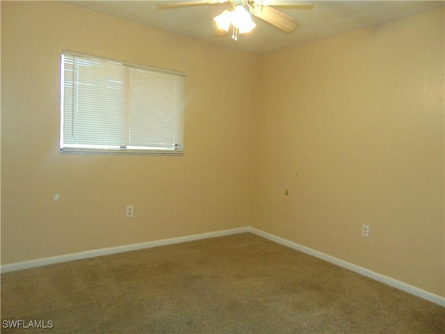 empty room with ceiling fan and carpet floors