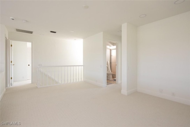 spare room with light colored carpet