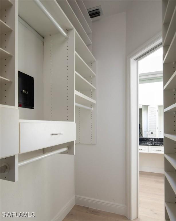 spacious closet featuring light hardwood / wood-style flooring