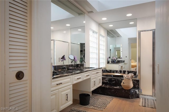 bathroom with vanity, wood-type flooring, and separate shower and tub