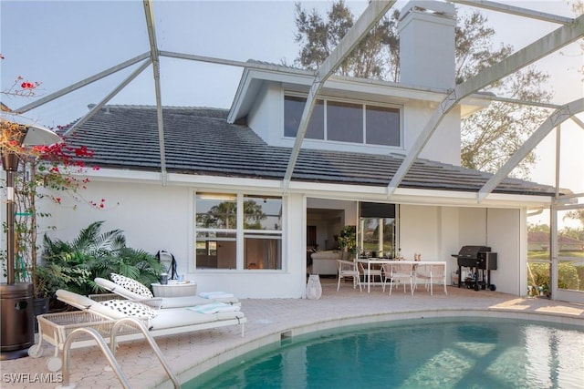 rear view of property featuring an outdoor living space, a lanai, and a patio area