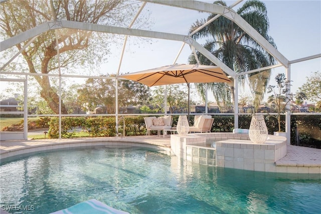 view of pool with glass enclosure