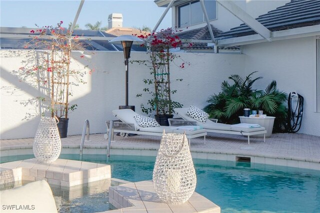 view of swimming pool with glass enclosure