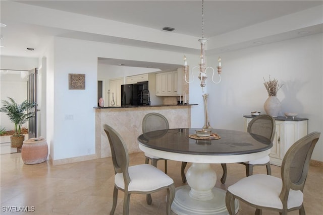 dining space featuring an inviting chandelier