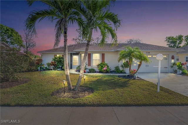 view of front facade featuring a lawn and a garage