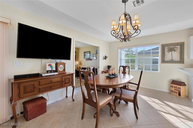 tiled dining room featuring an inviting chandelier