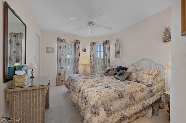 bedroom with ceiling fan and light carpet