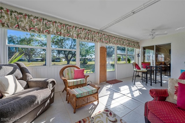 sunroom / solarium featuring ceiling fan