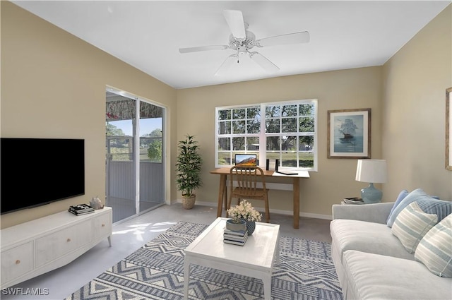 living room with ceiling fan, light colored carpet, and a healthy amount of sunlight