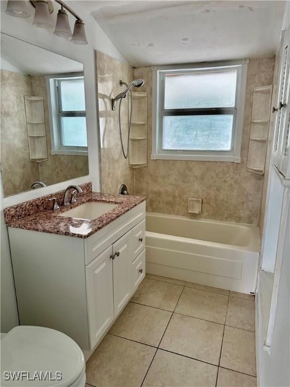 full bathroom featuring vanity, tile patterned flooring, tiled shower / bath combo, and toilet