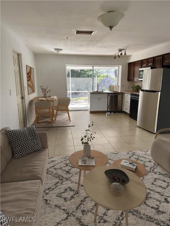 living room with sink and light tile patterned floors