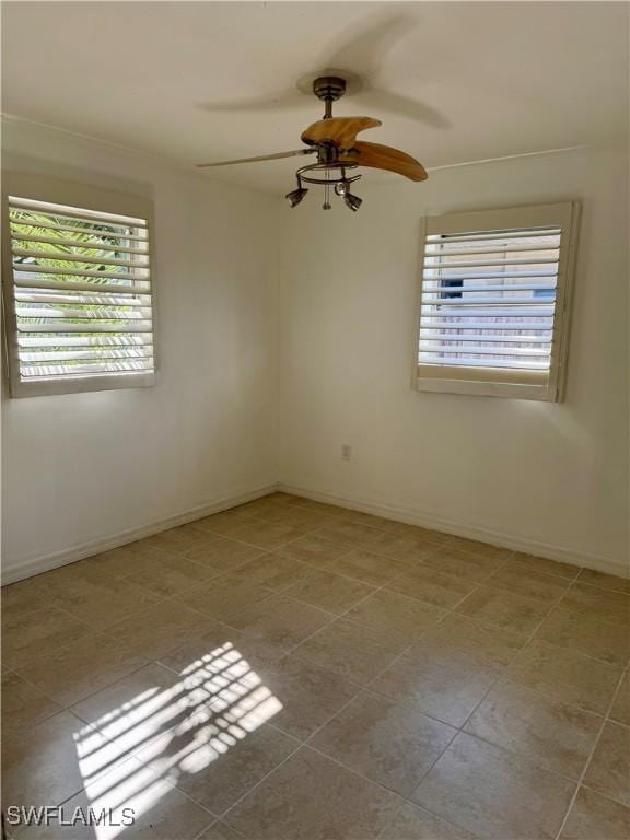 unfurnished room featuring ceiling fan and light tile patterned floors