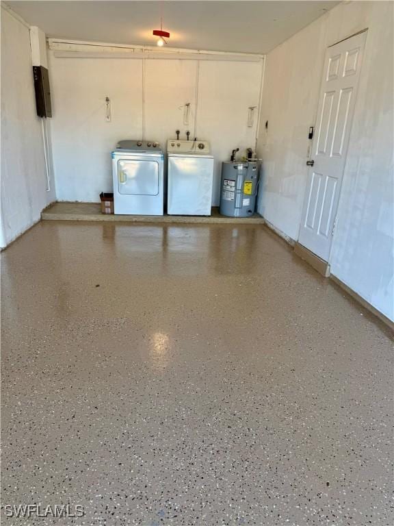 garage with washer and dryer and electric water heater