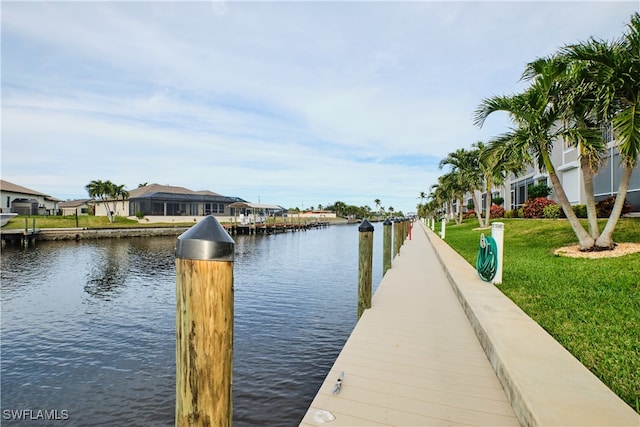 dock area featuring a water view and a yard