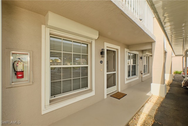 entrance to property with stucco siding