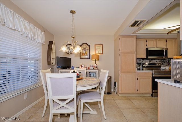 dining area featuring a notable chandelier and light tile patterned floors