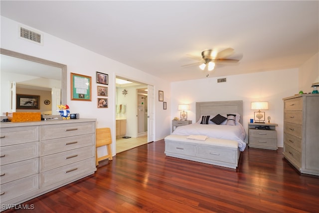 bedroom featuring dark hardwood / wood-style flooring, ceiling fan, and ensuite bathroom