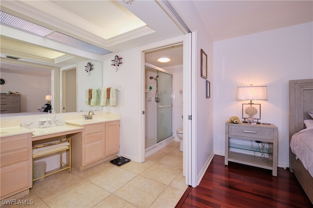 bathroom with vanity, ornamental molding, toilet, and walk in shower