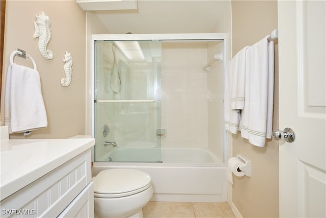 full bathroom featuring vanity, toilet, tile patterned flooring, and combined bath / shower with glass door