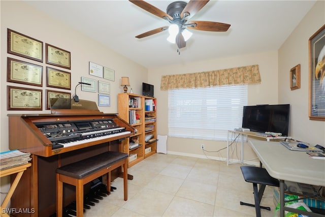 office featuring light tile patterned flooring, a ceiling fan, and baseboards