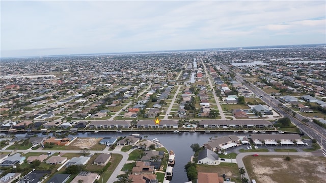 drone / aerial view with a residential view and a water view