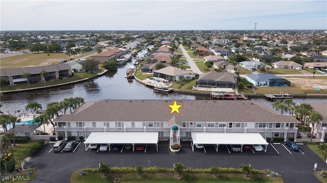 drone / aerial view with a residential view and a water view