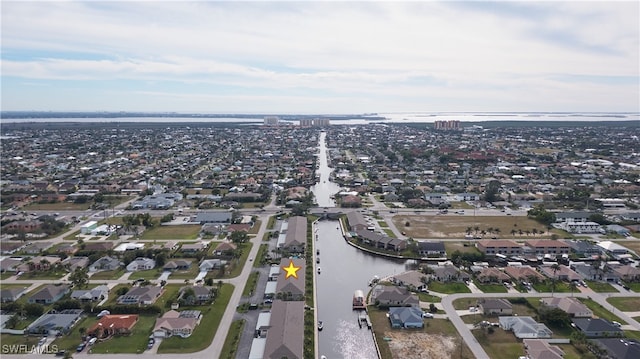 drone / aerial view with a water view and a residential view