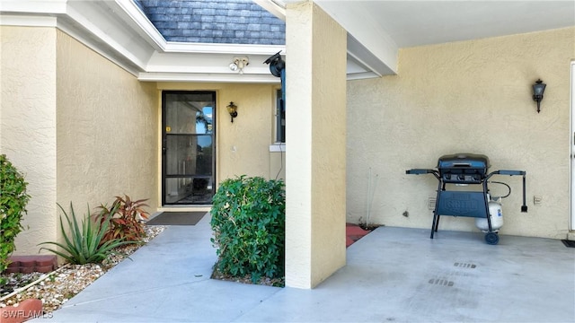 entrance to property with a patio