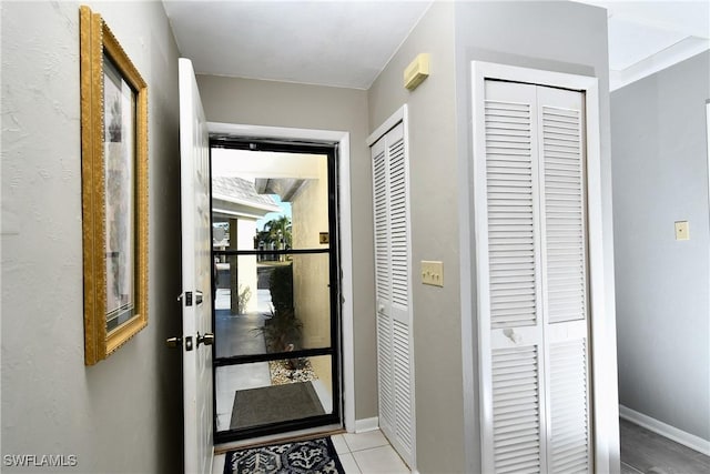 doorway to outside featuring light tile patterned floors