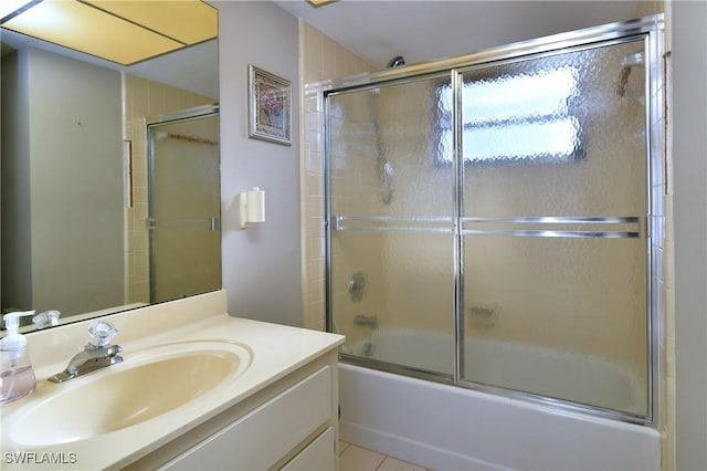 bathroom featuring shower / bath combination with glass door, vanity, and tile patterned flooring