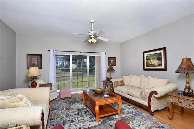 living room with hardwood / wood-style flooring and ceiling fan