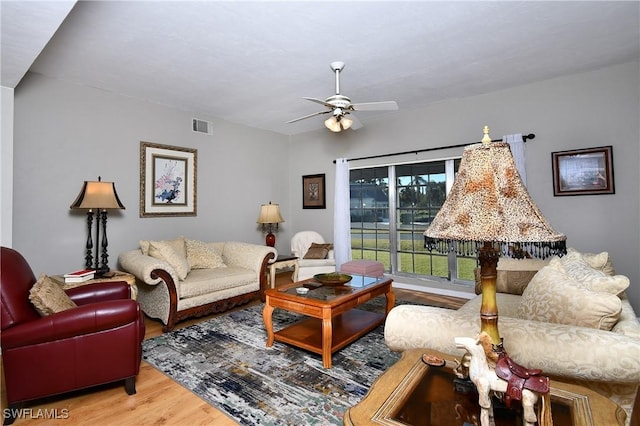 living room with hardwood / wood-style floors and ceiling fan