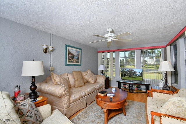 living room featuring a textured ceiling, hardwood / wood-style flooring, and ceiling fan